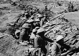 British soldiers peer at the enemy from the safety of their trench